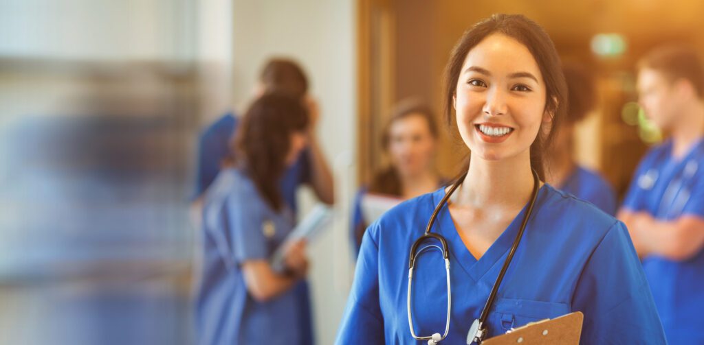 Medical student smiling at camera in university; Shutterstock ID 701320570; Purchase Order: comps; Job: ; Client/Licensee: ; Other: